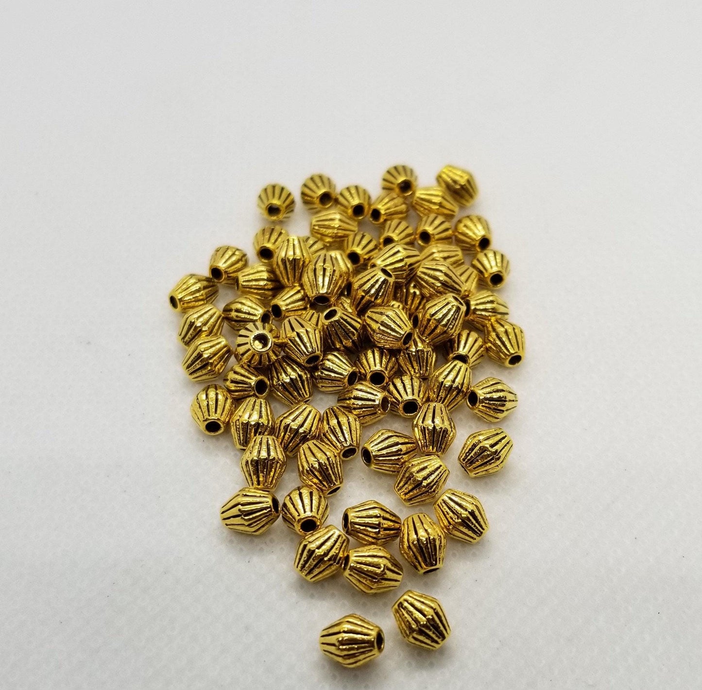 10 pieces Golden Bicone, Striated, Corrugated, Tibetan Style Alloy, Lead, Cadmium Free, Antique Golden, 5x6mm, hole 1mm