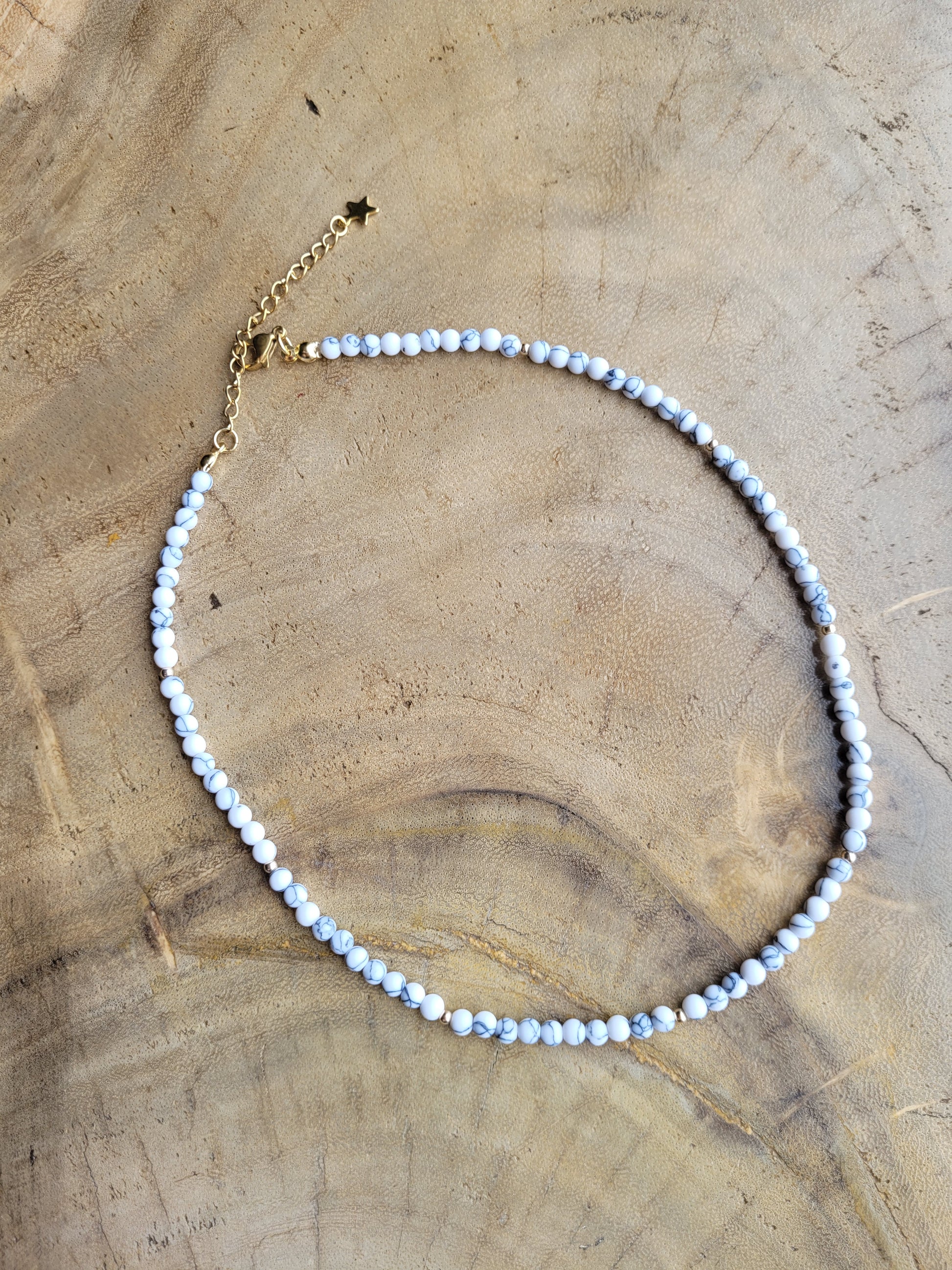 Howlite necklace on a wooden surface