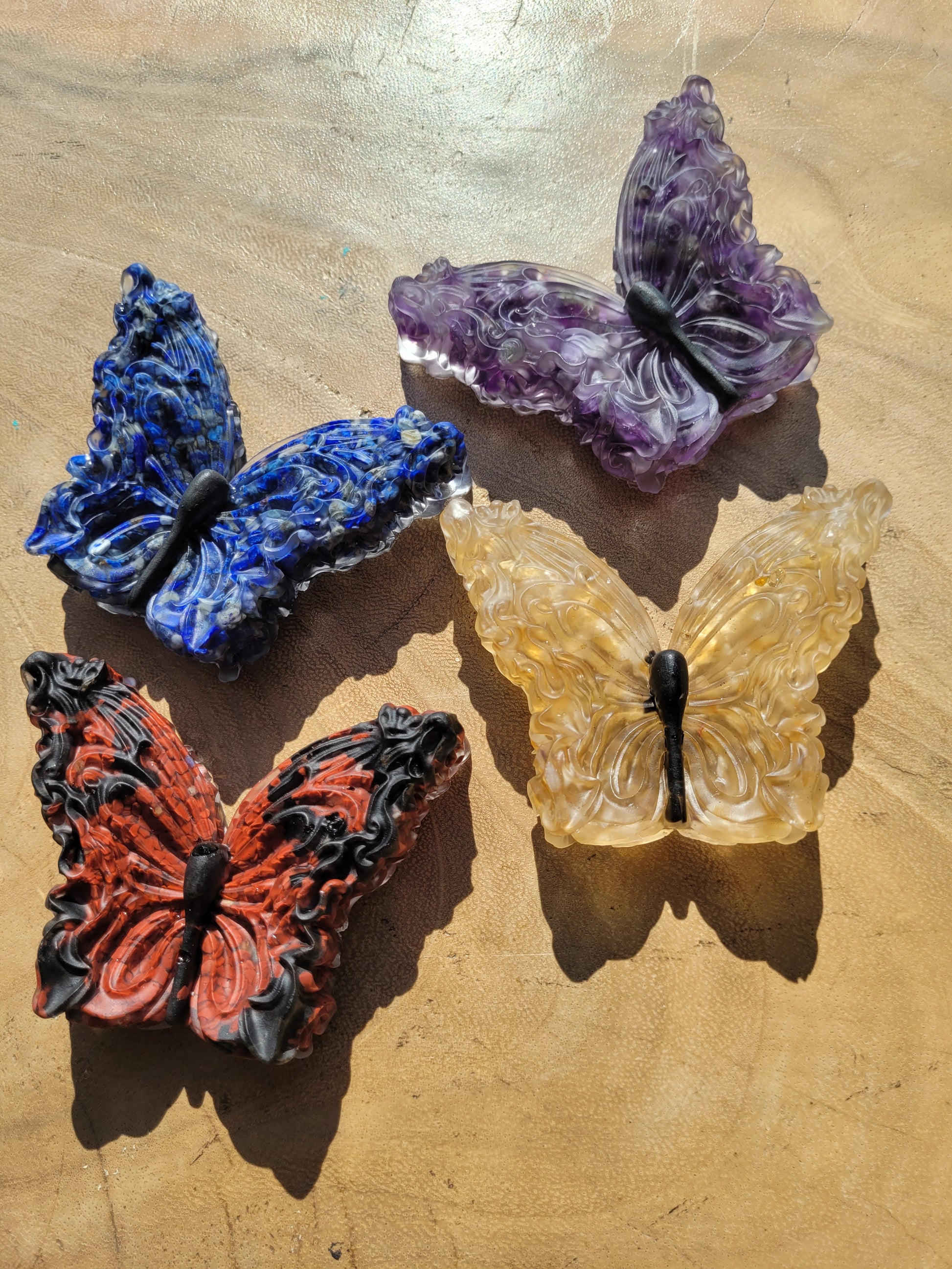 Four crystal and resin butterflies.